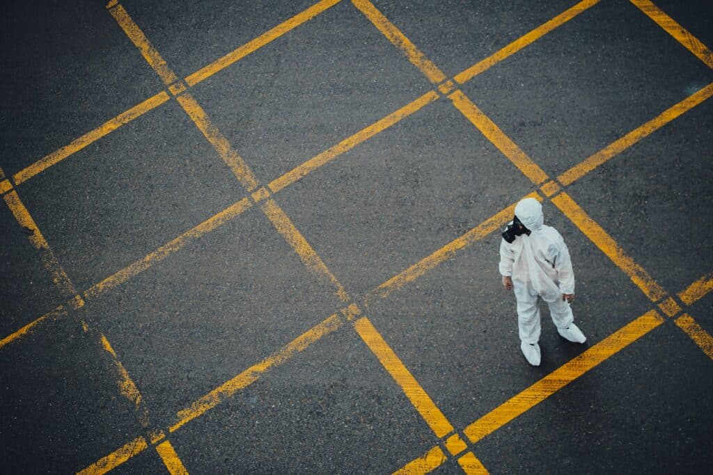 man in white thobe walking on grey and yellow concrete pavement