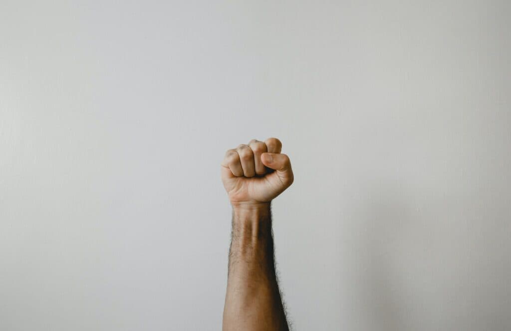persons right foot on white wall
