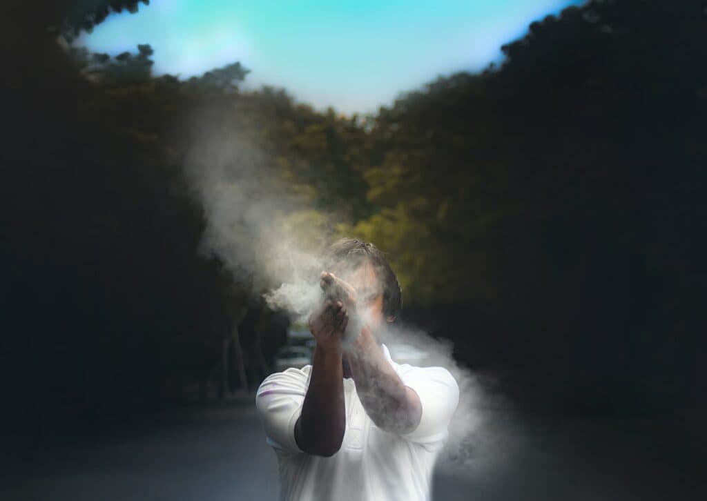 man in white t-shirt smoking
