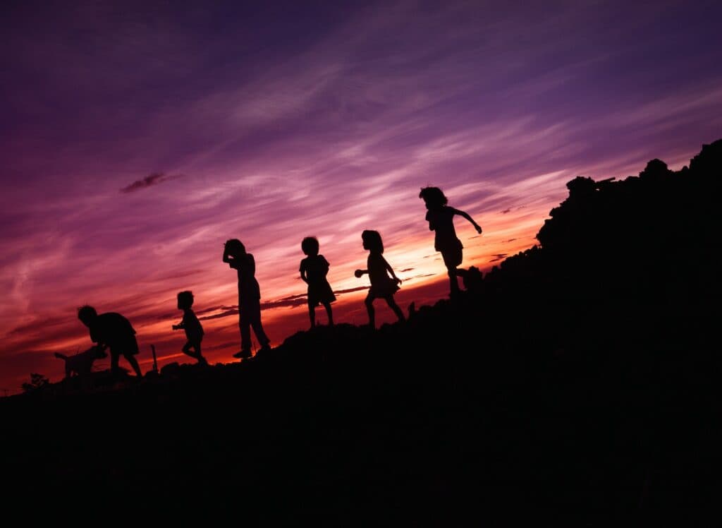 silhouette of children's running on hill