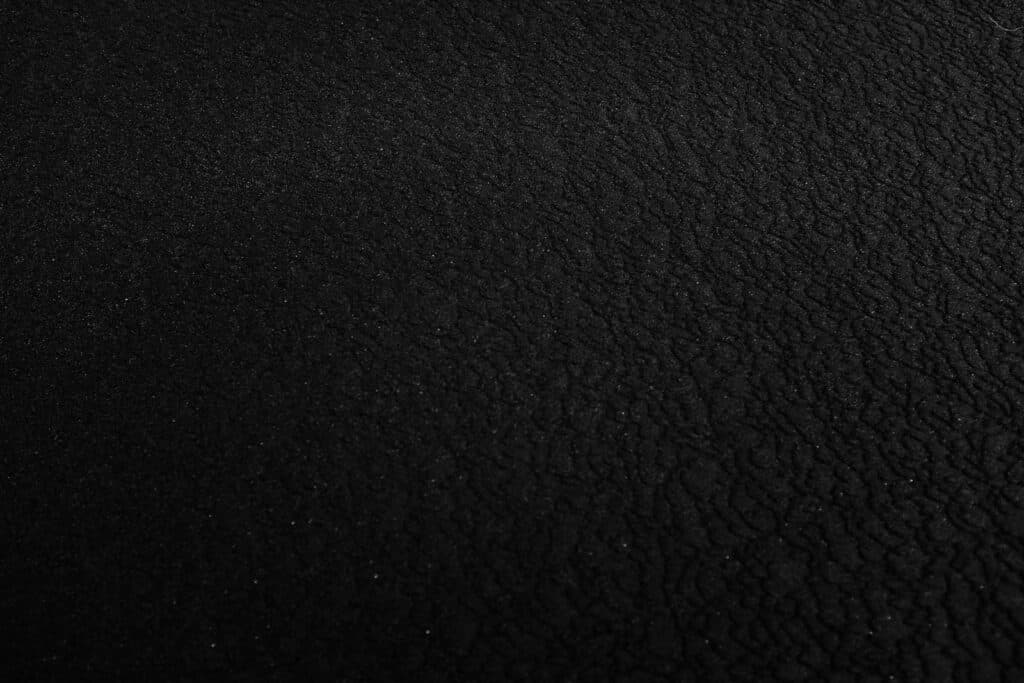 a black and white photo of a black surface