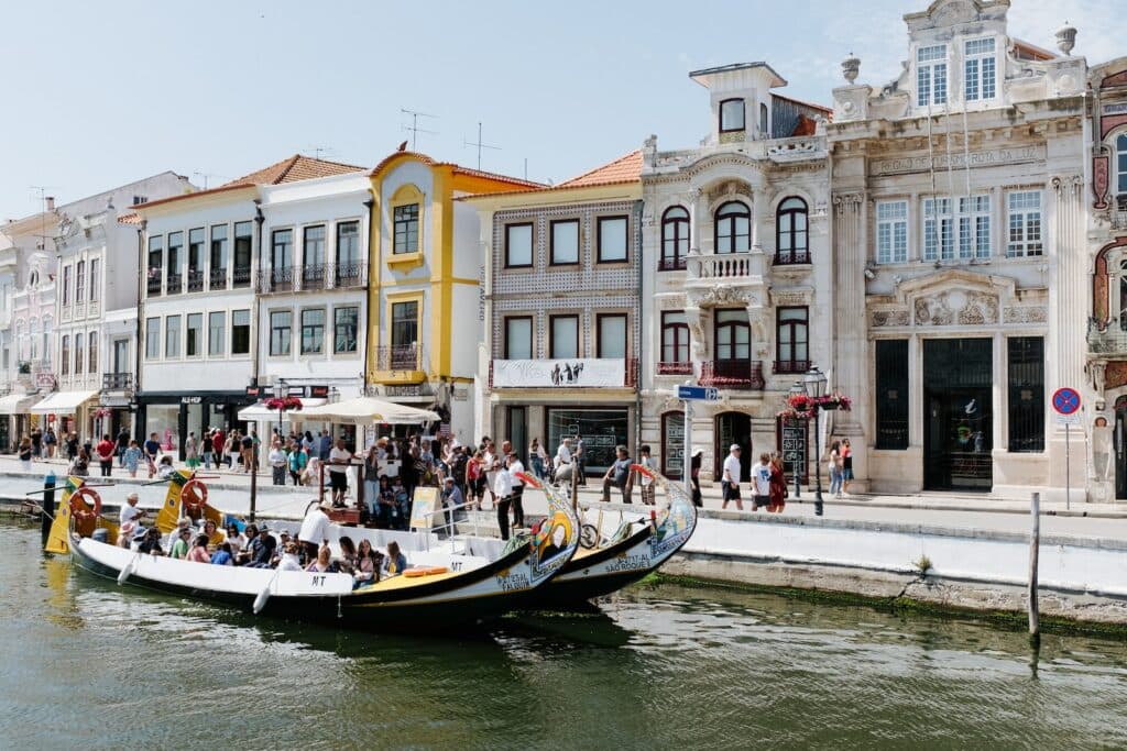 people in boat in front of buildings