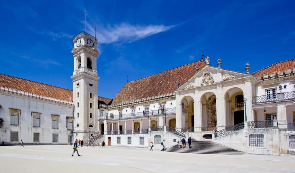 a large building with a clock tower in front of it