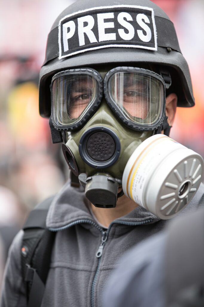person wearing black and white gas mask