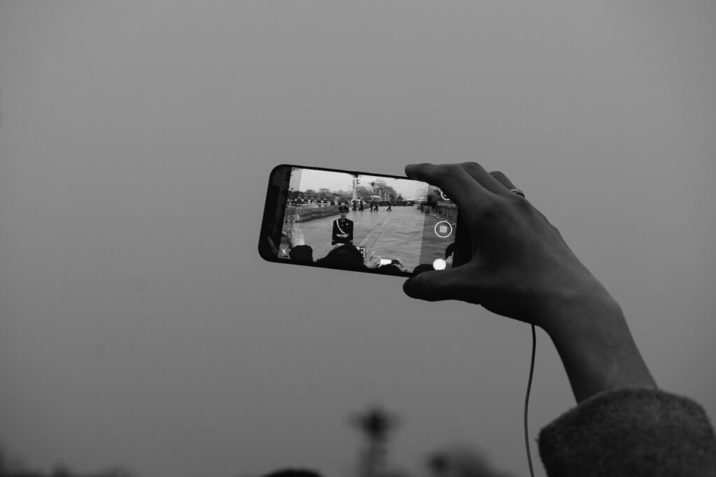 grayscale photo of person holding iphone 6