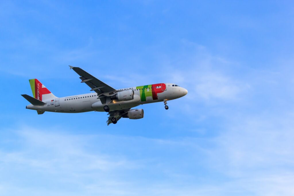 white, red, and green airliner