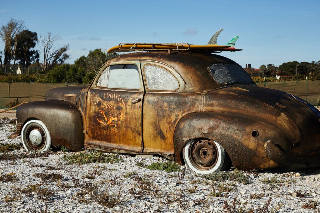 Vintage rusty broken car on gravel