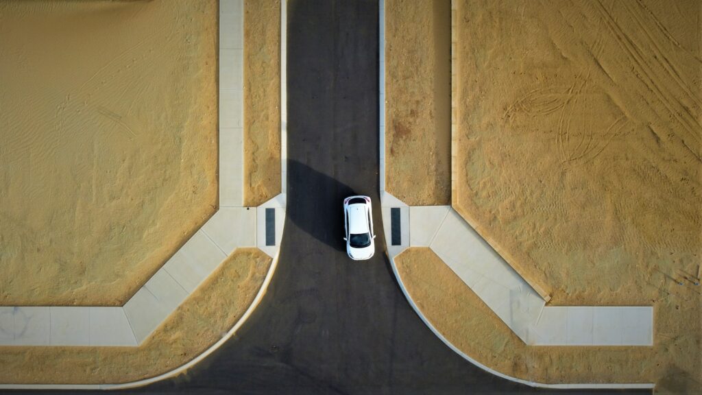 an aerial view of a car driving down a road