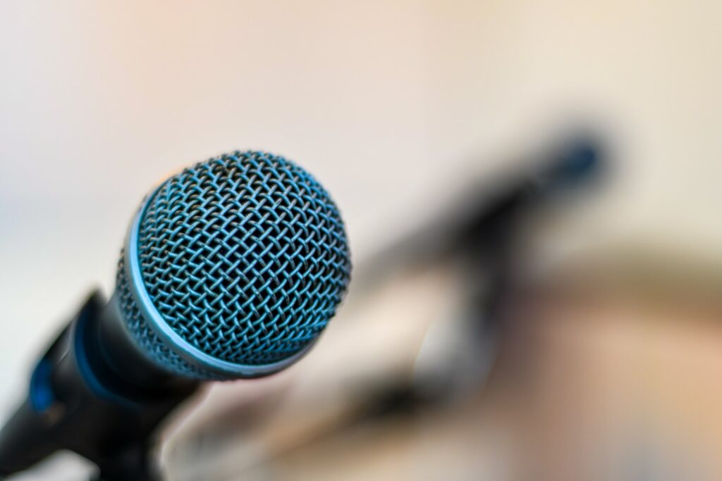 black microphone on brown wooden table