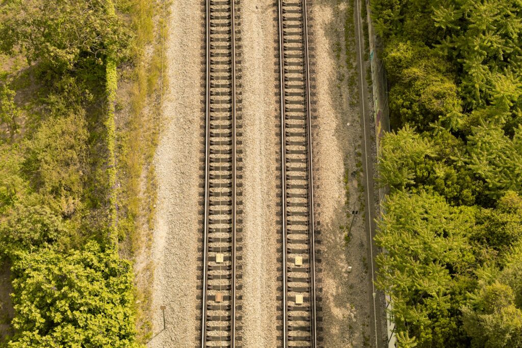 aerial photography of train tracks near forest