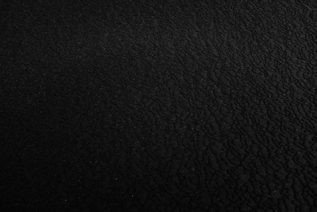 a black and white photo of a black surface