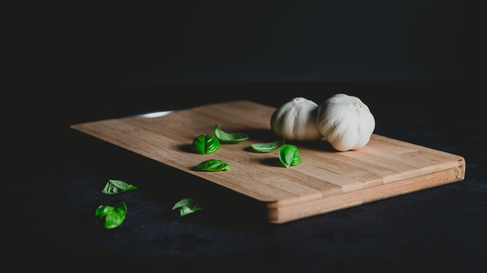 two bulb of garlic on top of chopping board