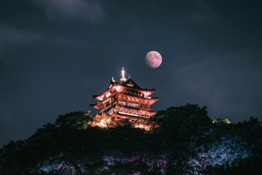 brown and white temple under full moon