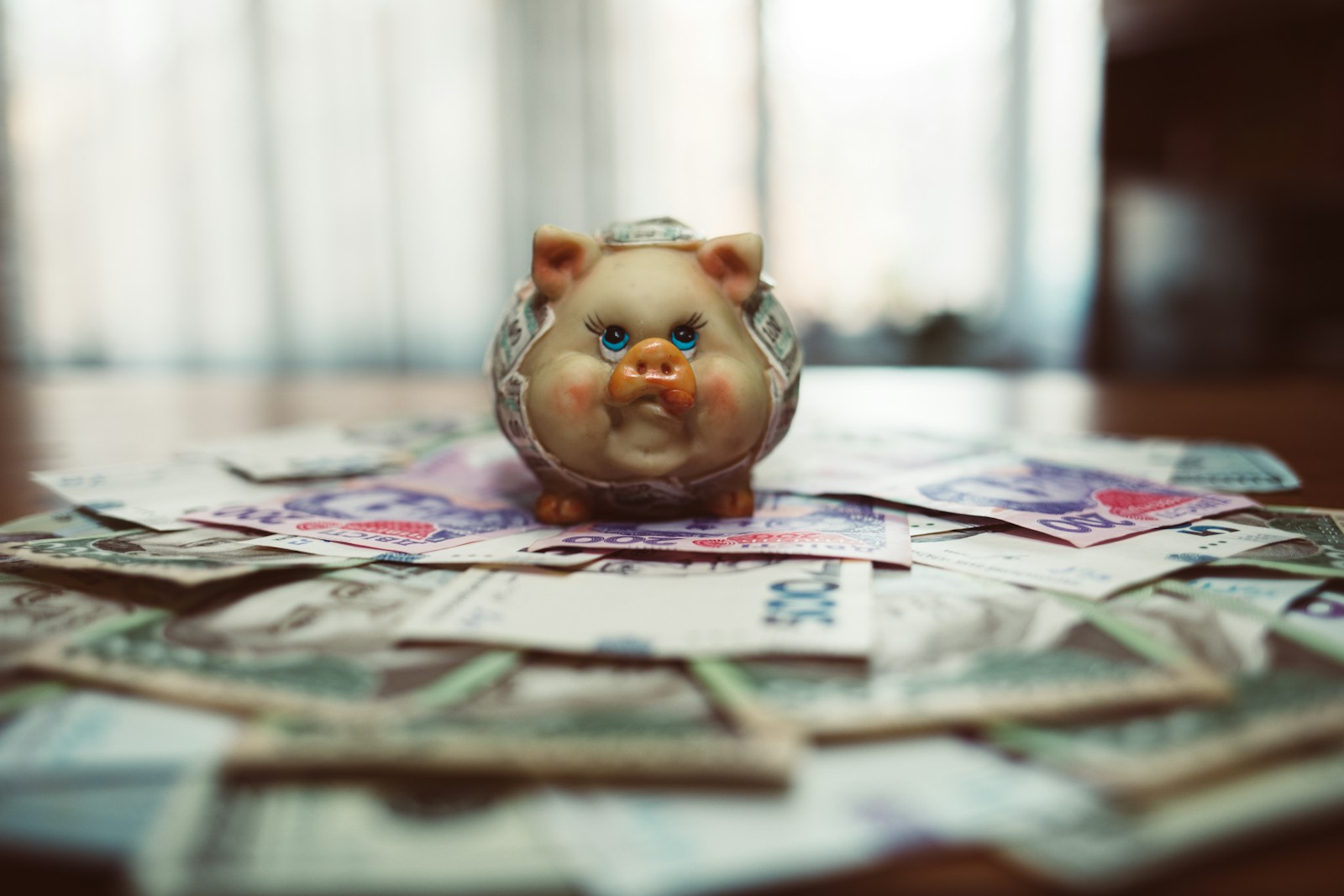 pink pig ceramic figurine on white newspaper