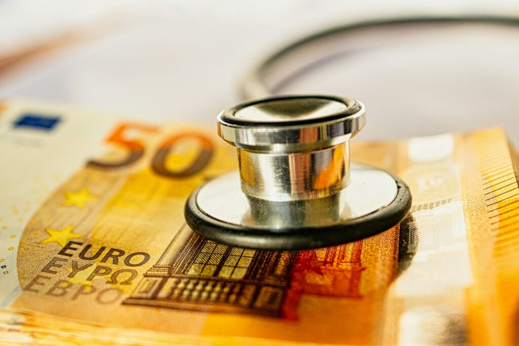 a stethoscope on top of a pile of money