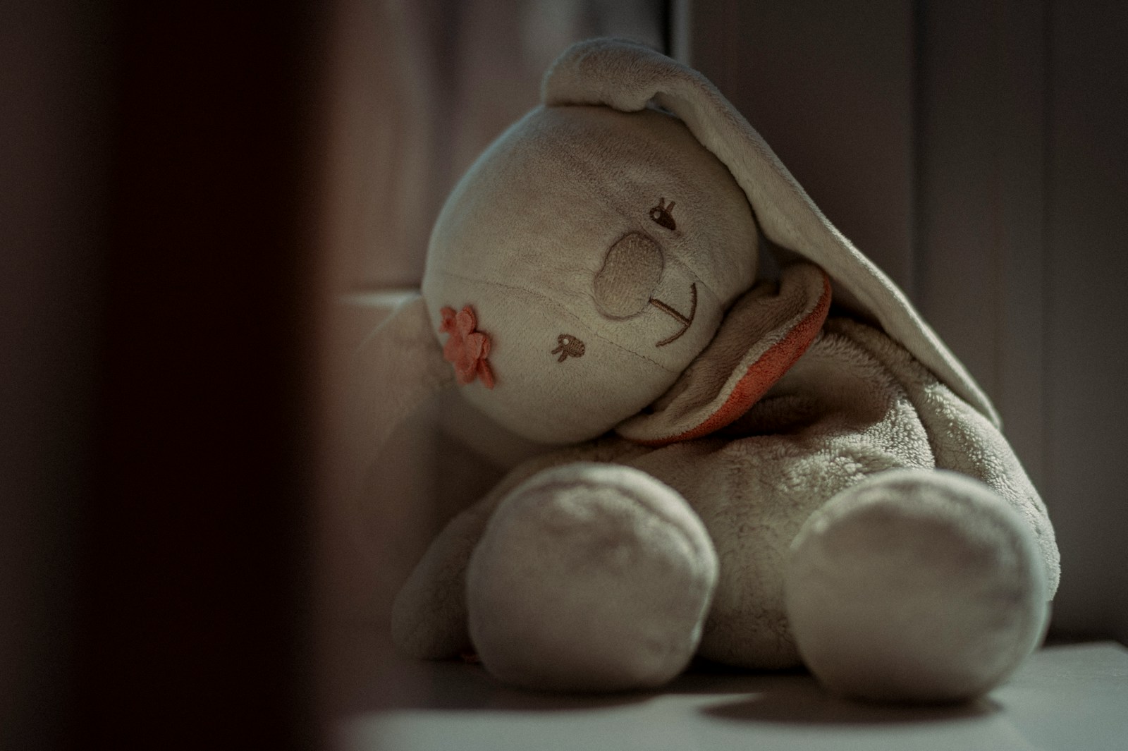 A white stuffed animal sitting on top of a table