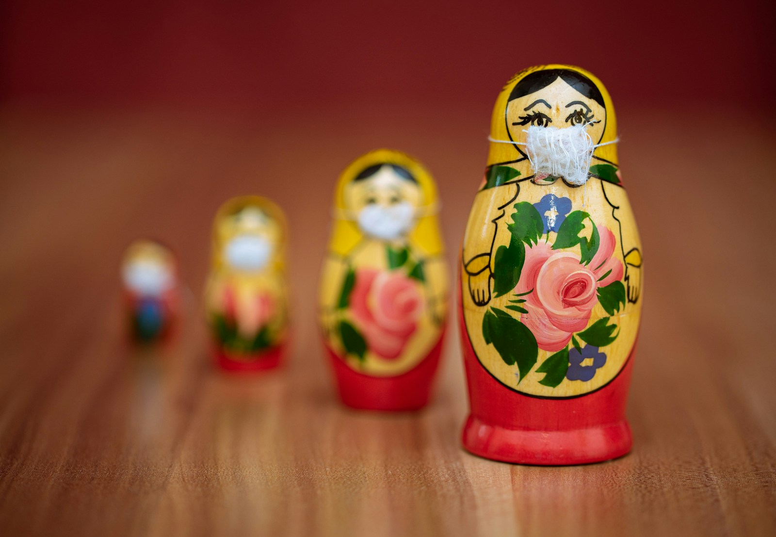 two yellow and red ceramic owl figurines