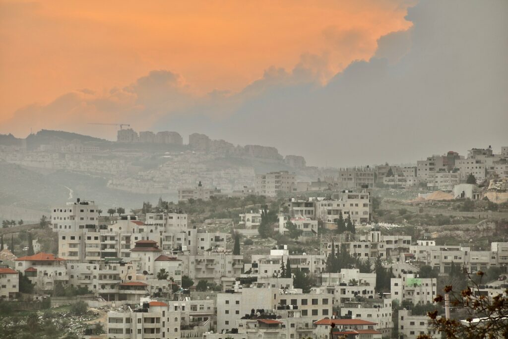 city with high rise buildings under orange sky