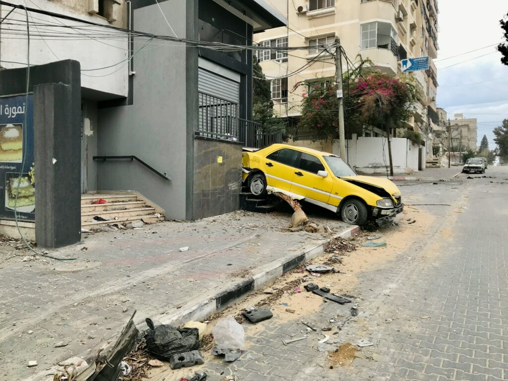 a yellow car is parked on the side of the road