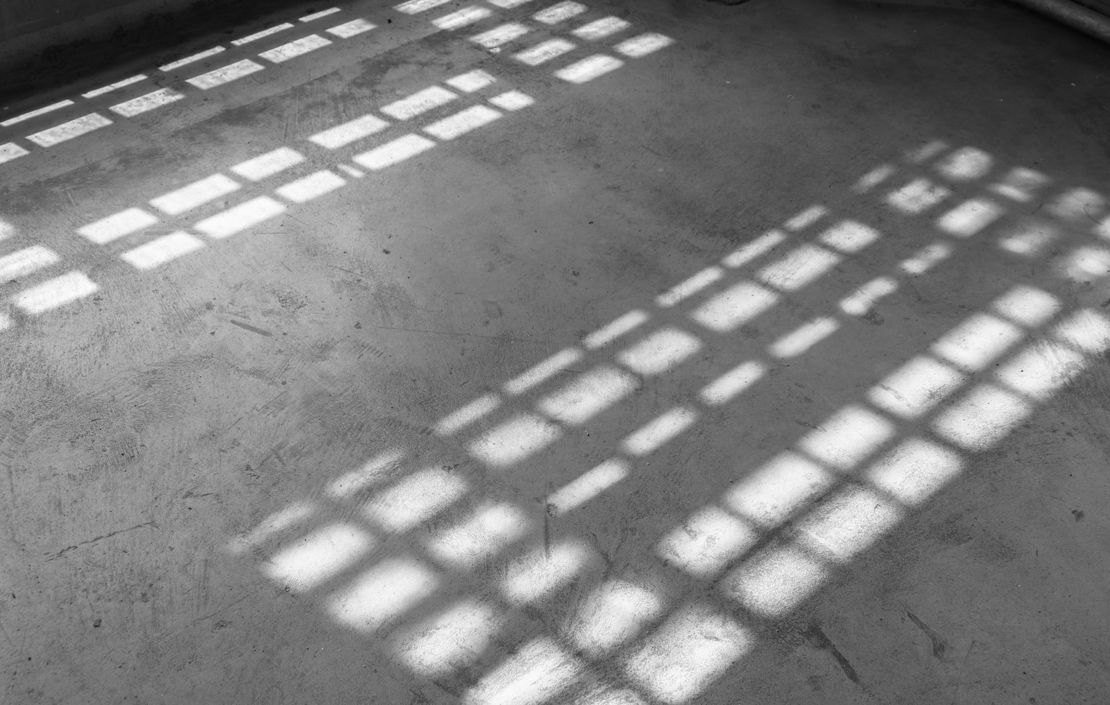 a black and white photo of a room with many windows